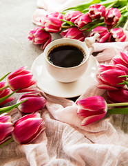 Fototapeta na wymiar Cup of coffee and tulips