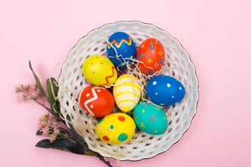easter eggs on plate on pink background
