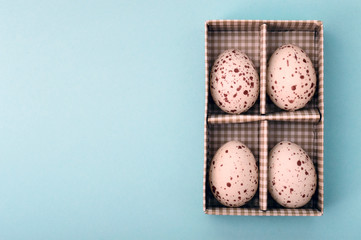 Easter concept eggs on blue background with copy space for text.