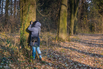 Girl at autumn in blue clothes exploring in the park