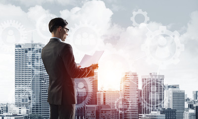 Concept of business success and control with confident boss against cityscape background