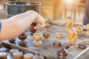 Close up Boy hand and mother are playing chess at home