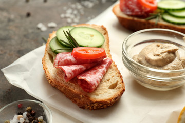 Fresh tasty bruschetta with sauce on grey background, closeup