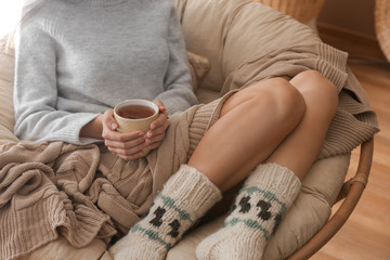 Young woman drinking hot tea at home