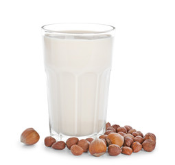 Glass of tasty hazelnut milk on white background