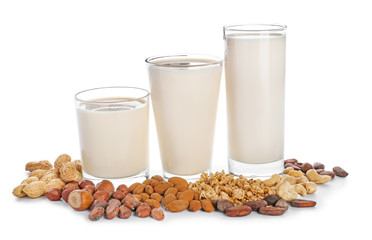 Glasses of different vegan milk on white background