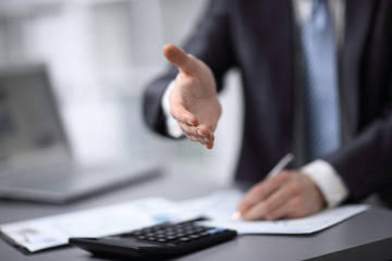 close up. businessman extending his hand to business partner