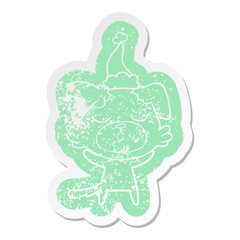 cute cartoon distressed sticker of a dog wearing santa hat