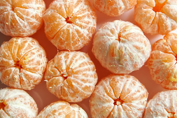 Peeled tangerine fruits. Whole mandarin citrus