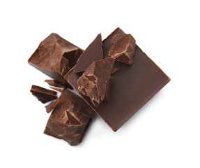 Pieces of tasty dark chocolate on white background