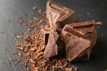 Pieces of tasty dark chocolate on table