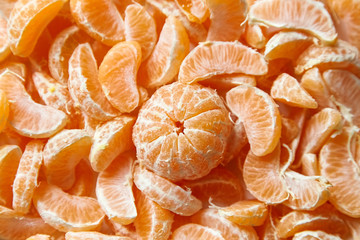 Peeled tangerine. Segments of mandarin fruit background