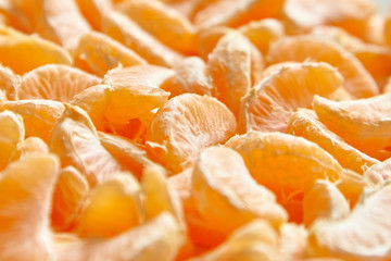 Peeled tangerine. Segments of mandarin fruit background