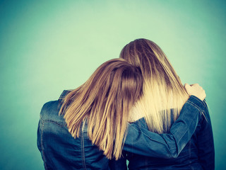 Back view of two women hugging