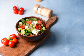 Healthy salad with feta cheese on light table
