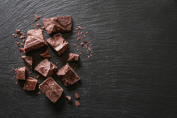 Sweet tasty chocolate on dark background