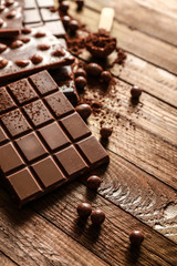 Sweet tasty chocolate on wooden background