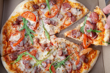  Round tasty pizza in a cardboard box with home delivery.