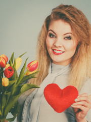 Woman holds tulips and red heart