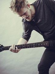 Man playing on electric guitar
