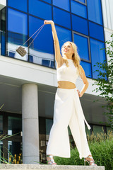 Cheerful fashionable woman in city