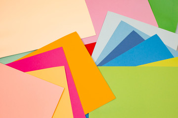 sheets of colored paper. Many colored sheets of paper are laid out in the harsh composition. background of colored paper.