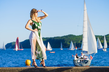 Woman in summer long dress against sea
