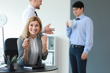 Woman playing a prank on her colleague in office. April Fools' Day prank