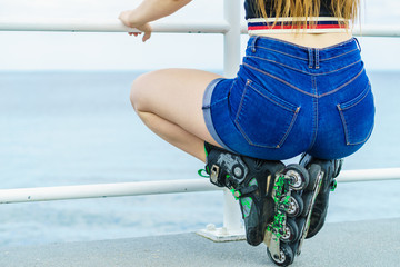 Back view woman wearing roller skates and shorts