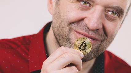 Man holding golden bitcoin