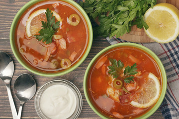 Two bowls with traditional Russian soup solyanka