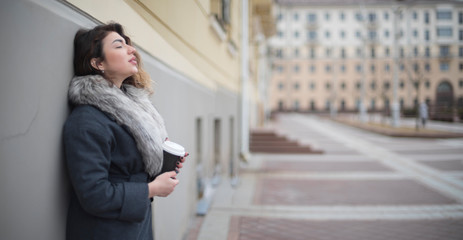 girl in a coat with coffee