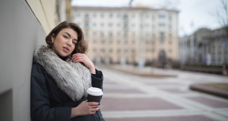 Fototapeta premium girl in a coat with coffee