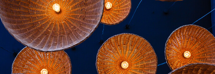 lamps in straw shades on the ceiling for decoration