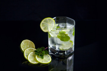 Summer cocktail mojito in glass on black background..