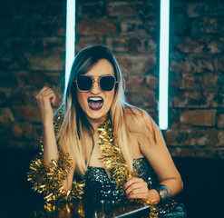 Young happy woman celebrating new year eve in night bar restaurant.