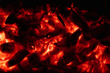 background glowing hot coals closeup. texture of burning coals