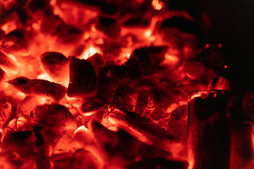 background glowing hot coals closeup. texture of burning coals