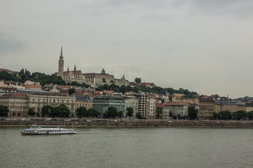 Budapest castle medieval architecture panorama view foreshortening from another side of Danube river in gray rainy cloudy autumn weather day time