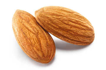 Close-up of two almonds, isolated on white background