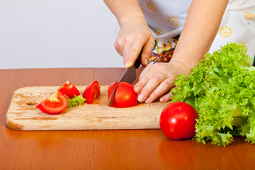 Women's hands are preparing a salad