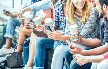 Millenial friends group using smartphone with coffee at university college - People hands addicted...