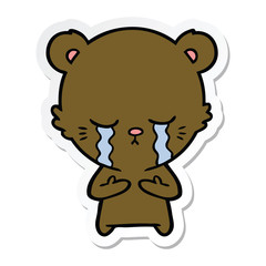 sticker of a crying cartoon bear