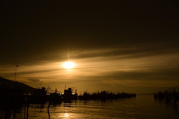 Fototapeta premium Fishing port view before sunset With beautiful golden yellow sky