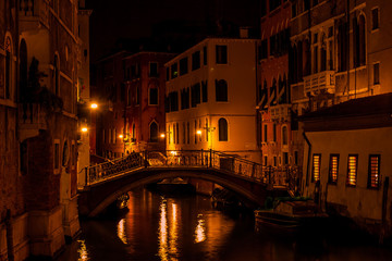 Obraz na płótnie Canvas Long exposure. View of the bridge over canal in Venice, Italy, at night.