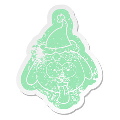 cartoon distressed sticker of a dog face panting wearing santa hat
