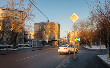 Taxi car on the road in Moscow city at sunset time. Moscow street at winter time in december. View...
