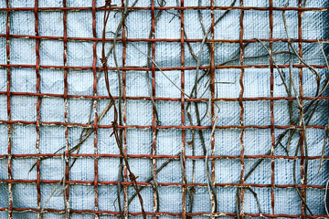 The background for the design of the old braided copper grille on a bright gray background close-up.