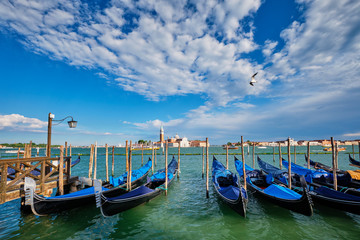 Fototapeta na wymiar Gondolas and in lagoon of Venice by San Marco square. Venice, Italy