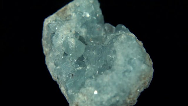 Seamlessly rotating a light blue mineral (Celestine) in front of black background